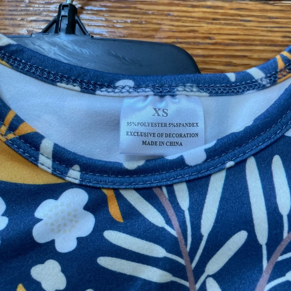 Girls striped toddler’s overalls with floral top.  Size XS (2T). No brand.